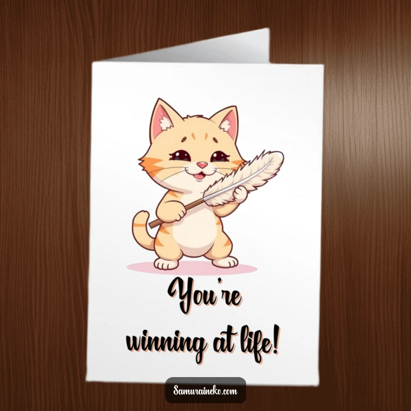 Funny Free Printable Congratulations Card: A cat gleefully attacks a feather duster, celebrating a humorous victory in its playful battle.