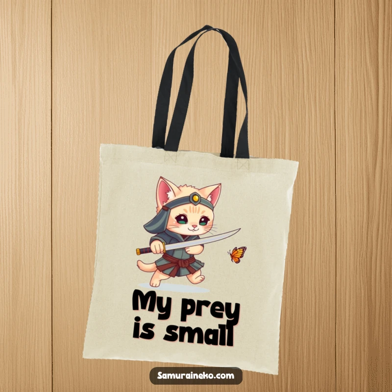Funny tote bag depicting a kitten samurai playfully chasing a butterfly with its sword, a humorous and practical accessory.